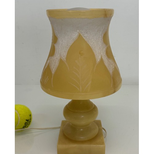 110 - A Carved stone table lamp, with hand carved floral and leaf designs to the shade section. 29 cm tall... 