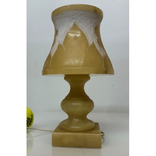 110 - A Carved stone table lamp, with hand carved floral and leaf designs to the shade section. 29 cm tall... 