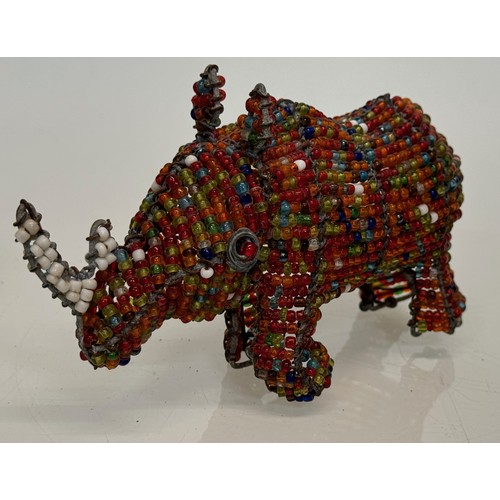 114 - Tribal art, a bead decorated rhino. 13 cm long

This lot is available for in-house shipping