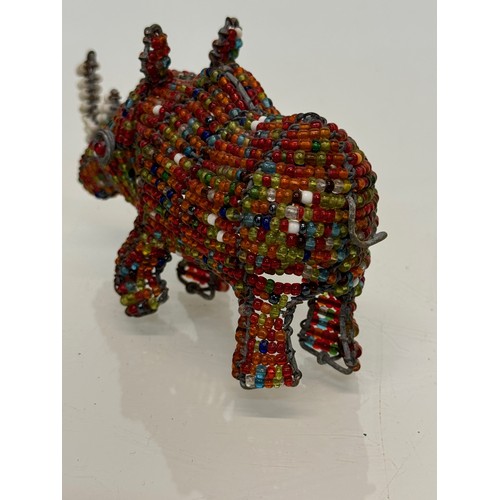 114 - Tribal art, a bead decorated rhino. 13 cm long

This lot is available for in-house shipping