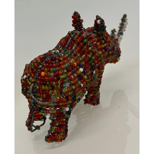 114 - Tribal art, a bead decorated rhino. 13 cm long

This lot is available for in-house shipping