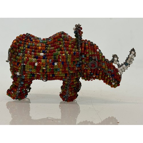 114 - Tribal art, a bead decorated rhino. 13 cm long

This lot is available for in-house shipping