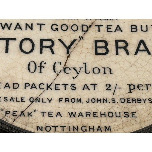 118 - Metal trivet with a ceramic heat stand to the centre advertising Victory Brand teas of Ceylon. 17 cm... 