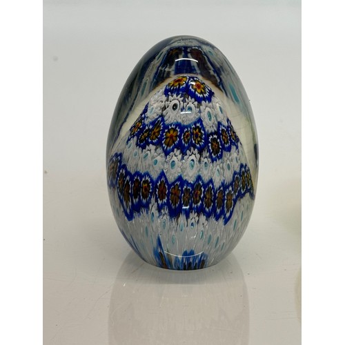 129 - Murano glass paperweight with a cut cane design inside, 9 cm tall.

This lot is available for in-hou... 