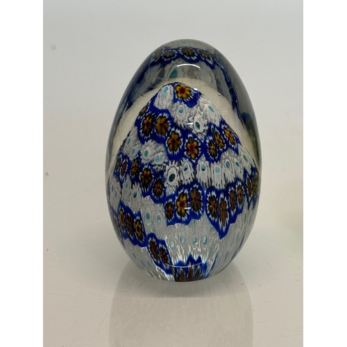 129 - Murano glass paperweight with a cut cane design inside, 9 cm tall.

This lot is available for in-hou... 