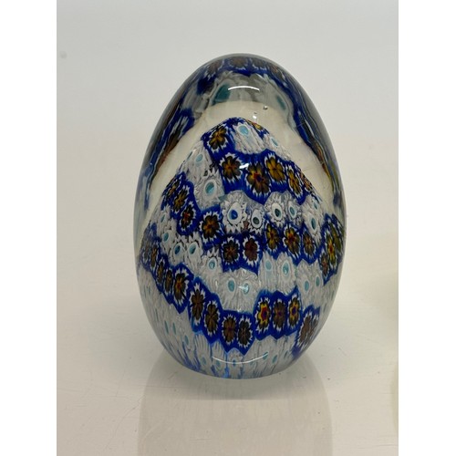 129 - Murano glass paperweight with a cut cane design inside, 9 cm tall.

This lot is available for in-hou... 