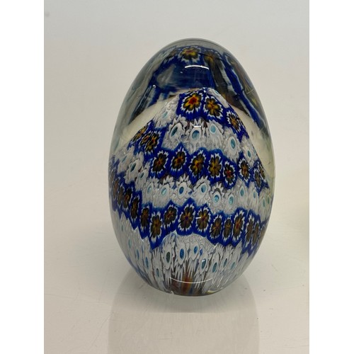 129 - Murano glass paperweight with a cut cane design inside, 9 cm tall.

This lot is available for in-hou... 