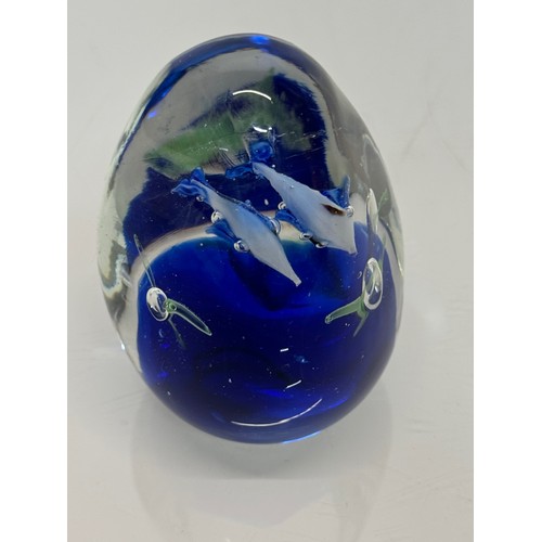 130 - Glass paperweight with two dolphin’s inside an underwater setting. 8 cm high.

This lot is available... 