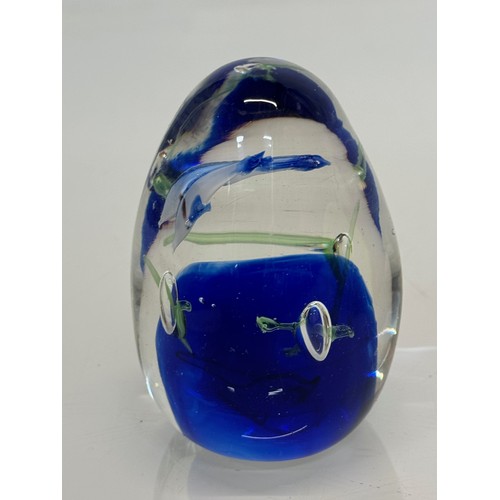 130 - Glass paperweight with two dolphin’s inside an underwater setting. 8 cm high.

This lot is available... 