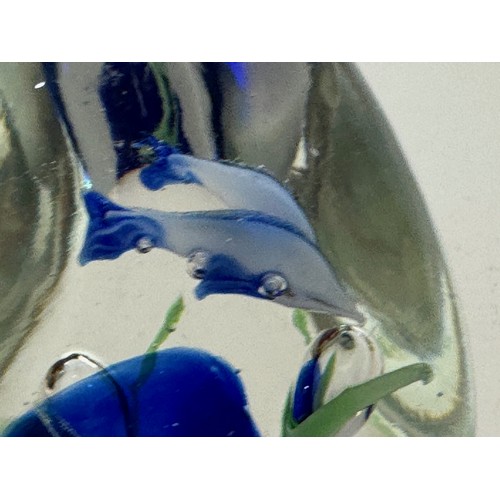 130 - Glass paperweight with two dolphin’s inside an underwater setting. 8 cm high.

This lot is available... 