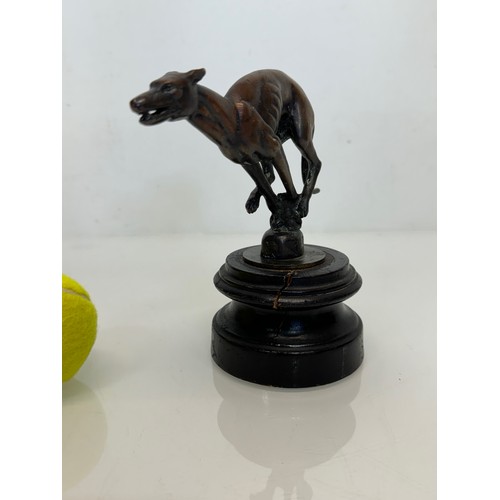 162 - Automobilia, a greyhound mascot marked for Colman on stand, 17 cm high.

This lot is available for i... 