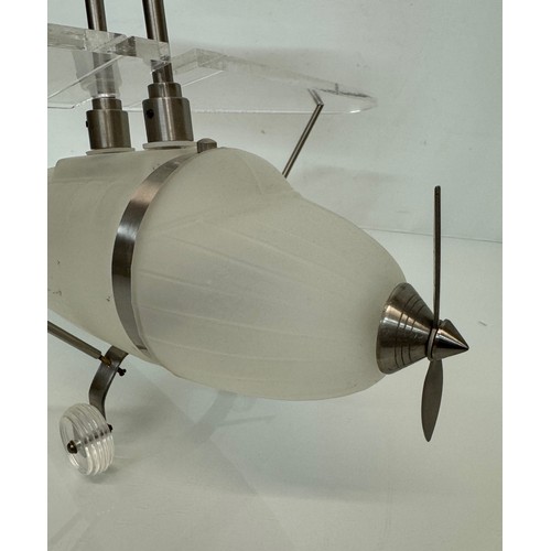 195 - Aeroplane ceiling light, moulded glass body 43 cm long 

This lot is available for in-house shipping