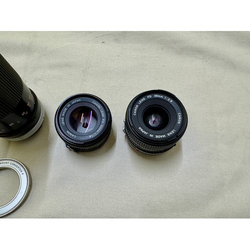 487 - Photographic equipment, A selection of lenses and a lens adapter for FD mount Canon 35mm Film Camera... 