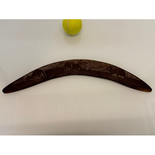 9 - Australian Aboriginal, tribal art, a boomerang decorated with carvings of kangaroo’s, 45 cm wide.

T... 