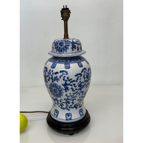 255 - Oriental design ceramic lamp base with a blue and white glazed base decorated with flowers. 44  cm h... 