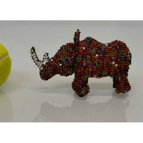 334 - Tribal art, a bead decorated rhino. 13 cm long

This lot is available for in-house shipping