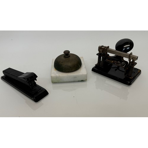 335 - Vintage office stationary accessories, a stapler, a desk bell and a painted steel hole punch.

This ... 