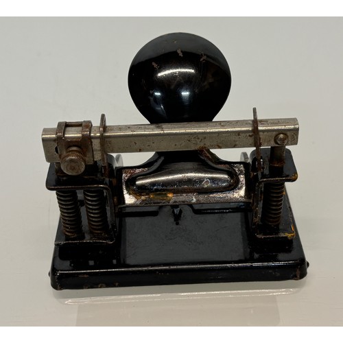 335 - Vintage office stationary accessories, a stapler, a desk bell and a painted steel hole punch.

This ... 