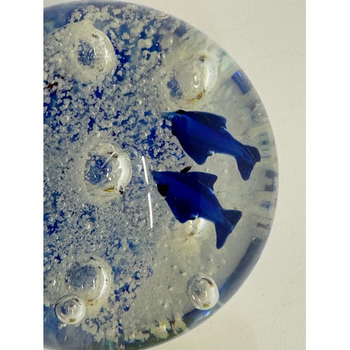 264 - A glass paperweight with blue fish set agains an oxigenated backdrop, 8 cm tall.

This lot is availa... 