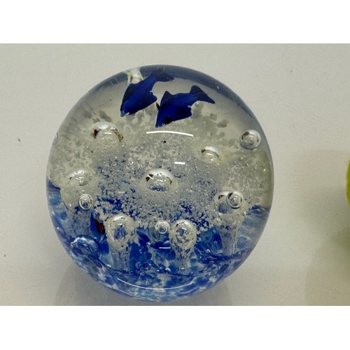 264 - A glass paperweight with blue fish set agains an oxigenated backdrop, 8 cm tall.

This lot is availa... 