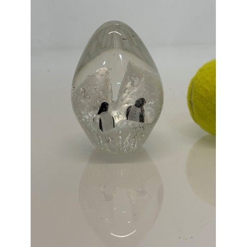 265 - A glass paperweight with two penguins inside against a background of ice cliffs. 10. cm tall.

This ... 