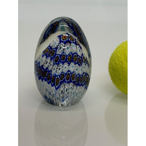 267 - A glass paperweight with a cut cane design inside, 9 cm tall.

This lot is available for in-house sh... 