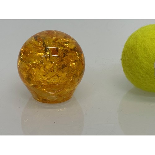 271 - An amber coloured resin paperweight, 6 cm high.

This lot is available for in-house shipping