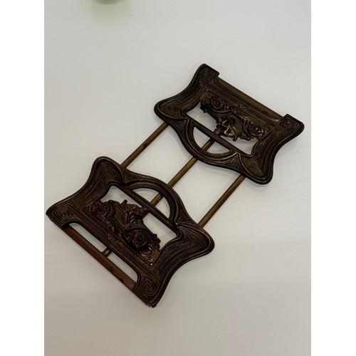 371 - Automobilia, a folding books stand the ends feature an Edwardian racing car at speed.

This lot is a... 