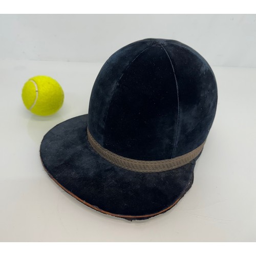 440 - Sporting equipment, a vintage deep blue velvet covered jockeys cap.

This lot is available for in-ho... 