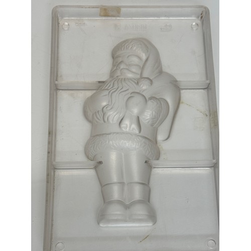 171 - Kitchenalia, three traditional Christmas chocolate moulds, Santa Claus, shoes and fish designs.

Thi... 