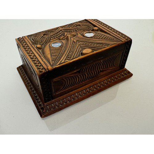 501 - Hand carved lidded box with a mask decoration to the lid with mother of pearl inserts, 12 cm x 9 cm ... 