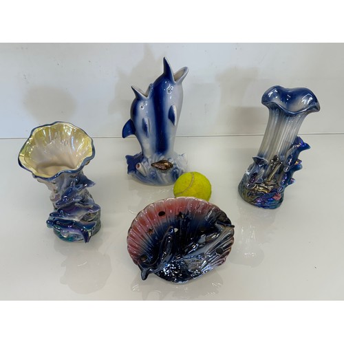 516 - A collectionm Kitsch lustre ware ceramicc,  vases etc all with a dolphin theme.

This lot is availab... 