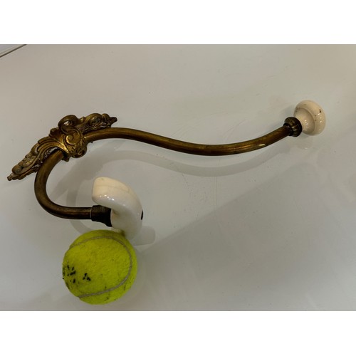 519 - Cast brass coat hanger of significant proportions 33 cm overall length. Lower coat hook finial is 11... 