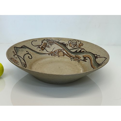 522 - Art pottery, a large stone ware bowl decorated with a dragon. 40 cm diameter x 10 cm high.

This lot... 