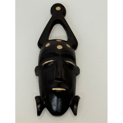 18 - Tribal Art, a hand carved hardwood head with bone inlays. 27 cm tall.

This lot is available for in-... 