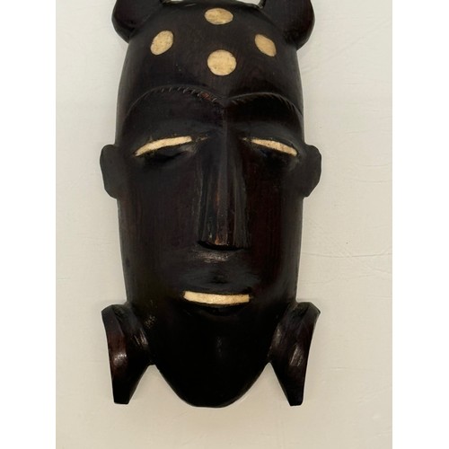 18 - Tribal Art, a hand carved hardwood head with bone inlays. 27 cm tall.

This lot is available for in-... 