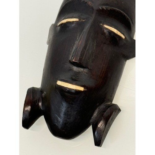 18 - Tribal Art, a hand carved hardwood head with bone inlays. 27 cm tall.

This lot is available for in-... 