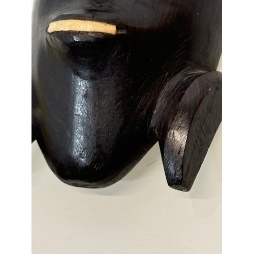 18 - Tribal Art, a hand carved hardwood head with bone inlays. 27 cm tall.

This lot is available for in-... 