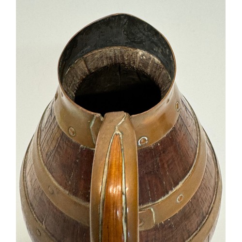 167 - A coopered oak jug with copper bindings, 20 cm tall.

This lot is available for in-house shipping