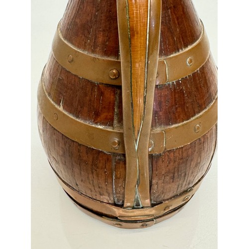 167 - A coopered oak jug with copper bindings, 20 cm tall.

This lot is available for in-house shipping