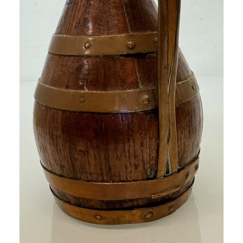 167 - A coopered oak jug with copper bindings, 20 cm tall.

This lot is available for in-house shipping