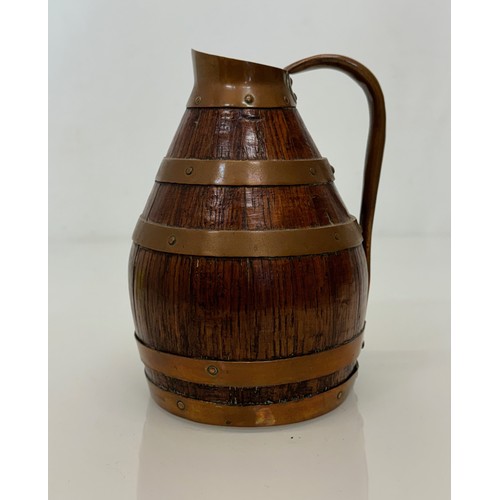 167 - A coopered oak jug with copper bindings, 20 cm tall.

This lot is available for in-house shipping