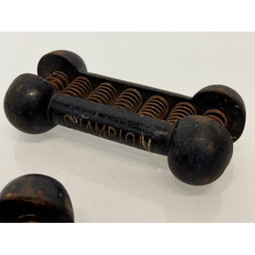 180 - Vintage body building and sports equipment, a pair of Champion brand cast iron weighted resistance s... 