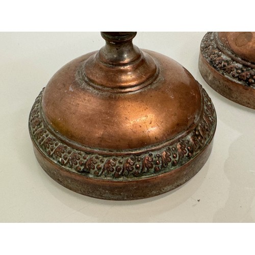 181 - A pair of cast copper candle stands, 25 cm tall.

This lot is available for in-house shipping