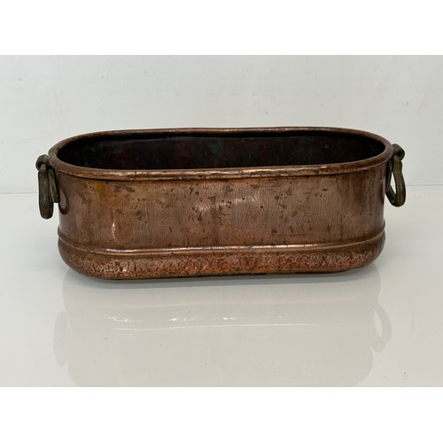 182 - A copper planter with cast brass handles, 40 cm x 17 cm x 14cm high.

This lot is available for in-h... 