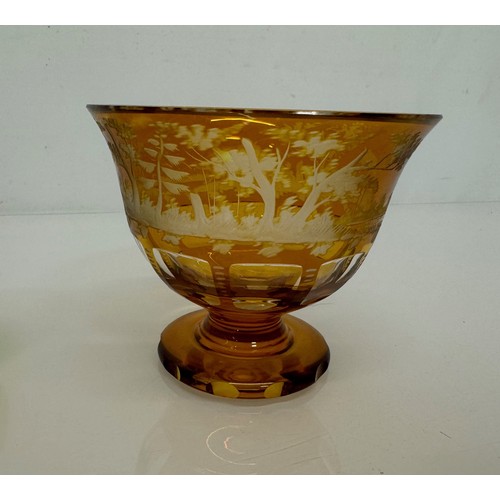 193 - Wheel cut amber glass bowl decorated with deer in a woodland setting, 13 cm diameter x 10.5 cm high.... 