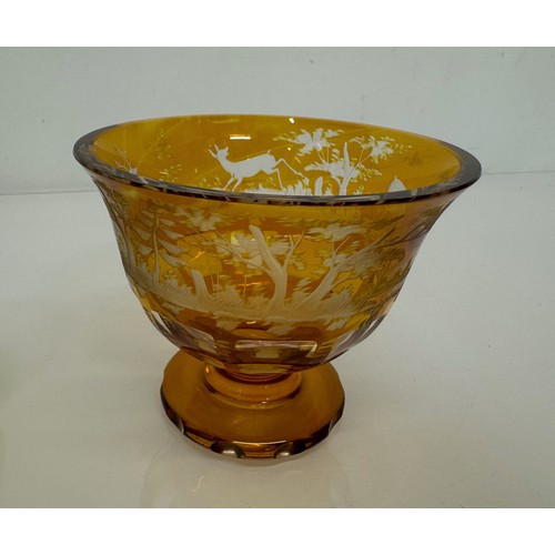 193 - Wheel cut amber glass bowl decorated with deer in a woodland setting, 13 cm diameter x 10.5 cm high.... 