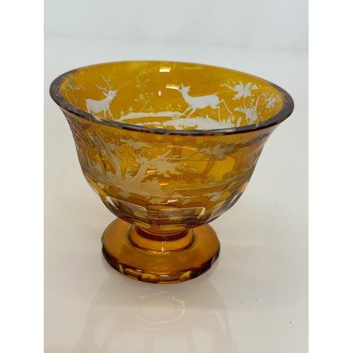 193 - Wheel cut amber glass bowl decorated with deer in a woodland setting, 13 cm diameter x 10.5 cm high.... 