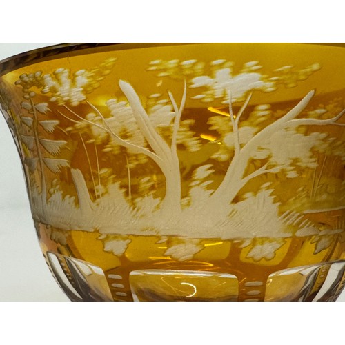 193 - Wheel cut amber glass bowl decorated with deer in a woodland setting, 13 cm diameter x 10.5 cm high.... 