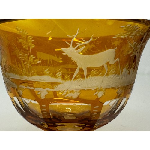 193 - Wheel cut amber glass bowl decorated with deer in a woodland setting, 13 cm diameter x 10.5 cm high.... 